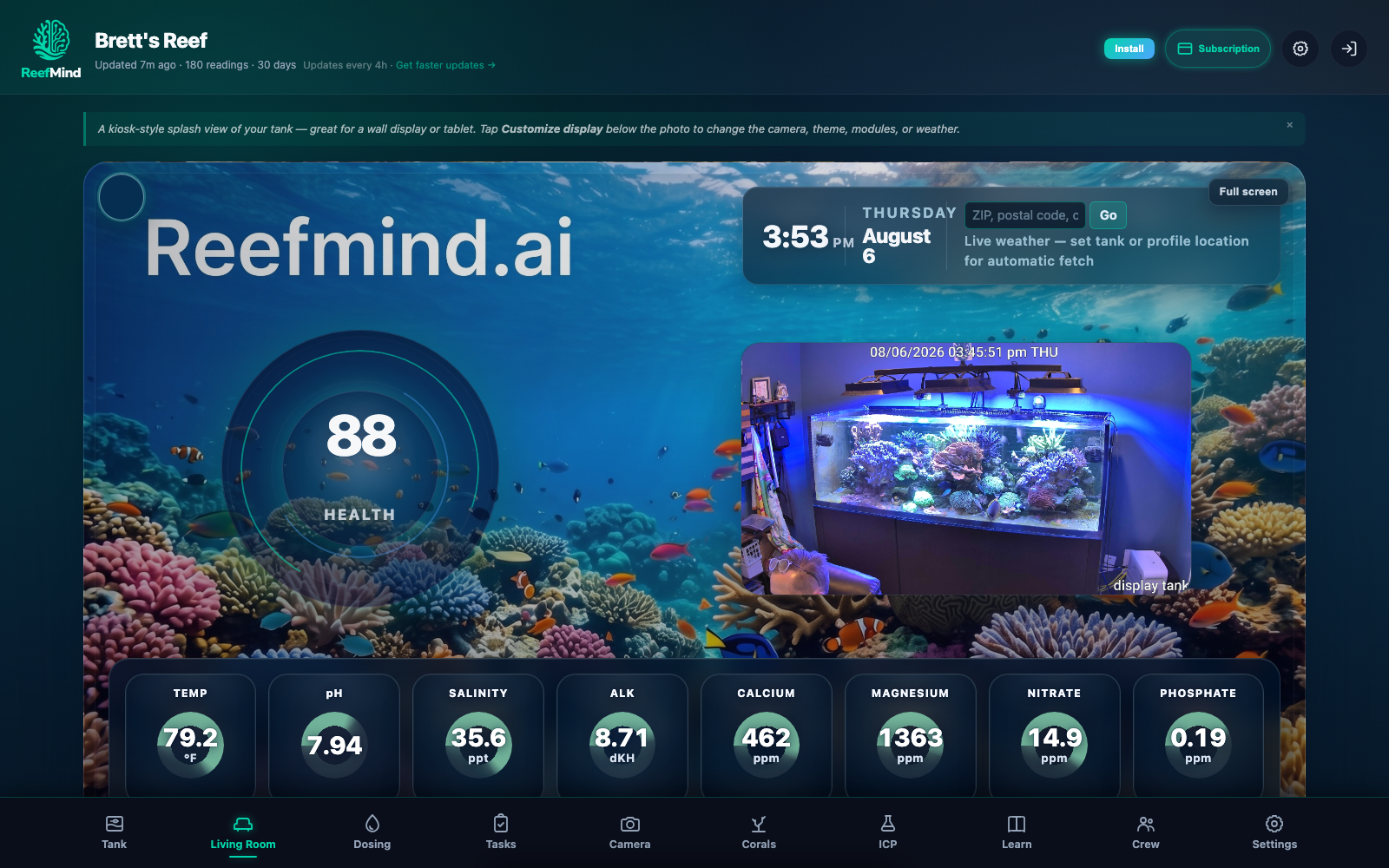 Full ReefMind production demo on the Living Room tab, with a vibrant reef wall display beside tank status, time, and weather